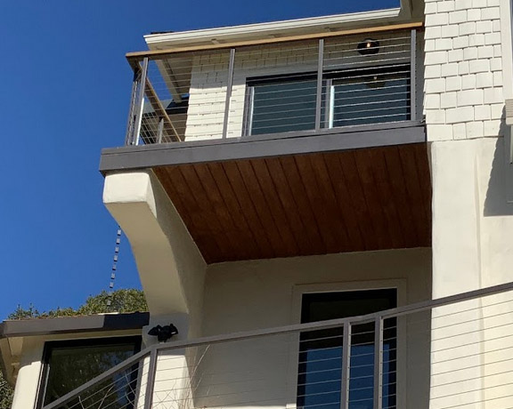 Balcony cable railing system with wood finishing